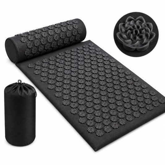 Black acupressure recovery mat set with matching pillow and carry bag displayed on a plain white background, featuring lotus-shaped pressure points designed for relaxation, stress relief, and muscle recovery.