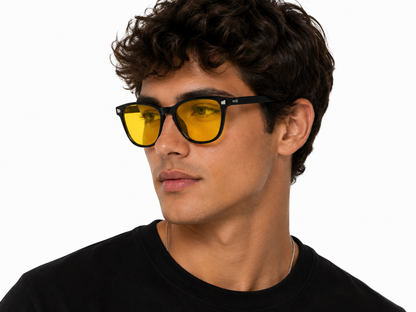 Male model wearing Deep Drift Honey Glow blue light blocking sleep glasses with yellow lenses designed to reduce eye strain and support better sleep