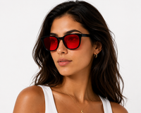 Model wearing Deep Drift blue light blocking sleep glasses with red lenses designed for evening screen use and night-time routines